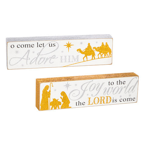 Nativity signs with text overlay of O Come Let Us Adore Him or Joy to the World