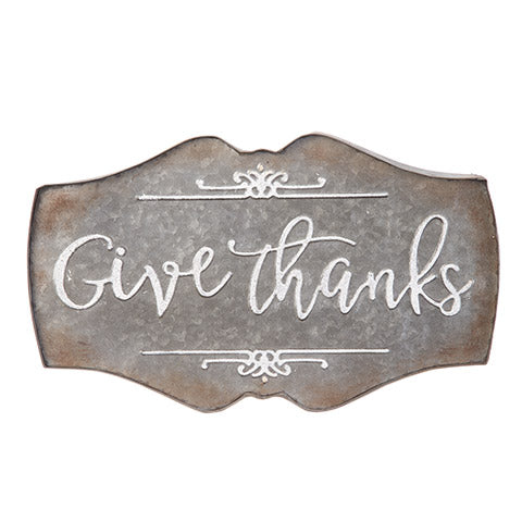 Galvanized metal sign with Give Thanks embossed in white lettering
