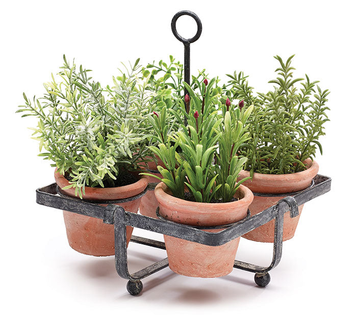 Four artificial herbs in clay pots in a black metal holder
