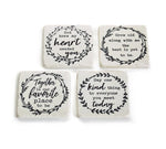 Square set of 4 white, faux stone coasters, each with a printed wreath and a different inspirational saying w